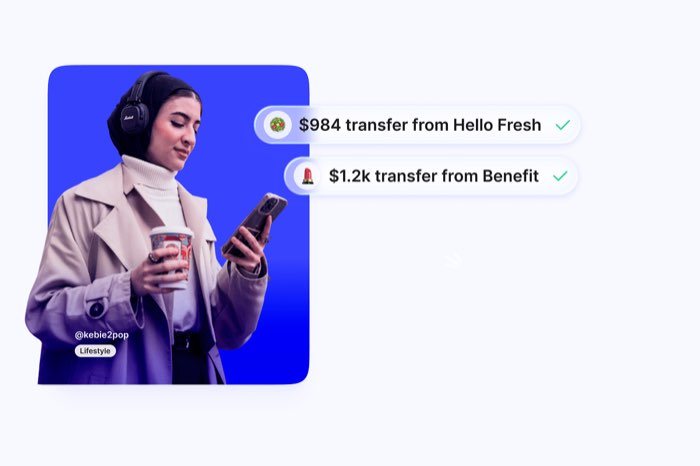 Illustration showing a creator looking down smiling at their phone: they've received two notification of payment from collabs, via Upfluence Pay.